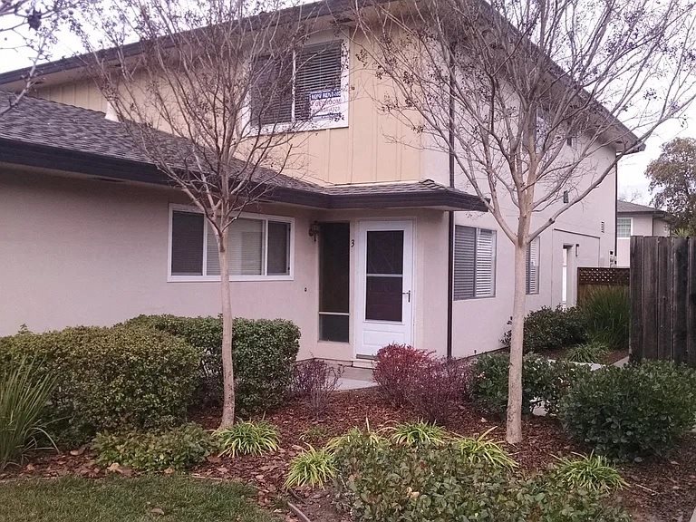 1335 Scossa Avenue #3, San Jose, CA 95118
 A house with a white door and two windows with trees in front.
